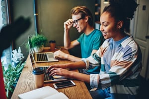 co-workers typing on laptops