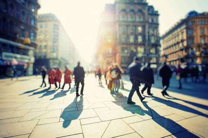 Pedestrians walking through a city street.